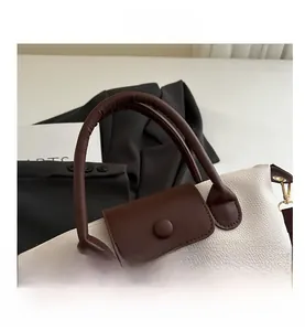 Macro view of textured lychee grain leather tote bag with contrast stitching and handle