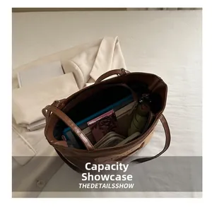 Close-up of brown canvas tote bag interior showing spacious storage capacity and pockets