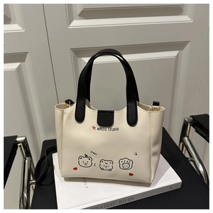 Détail du sac seau minimaliste avec illustrations d'ours et doubles poignées
