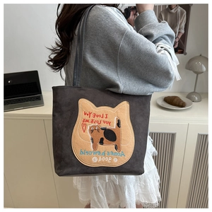 Detail view of dark grey suede tote bag with cute cat embroidery and long shoulder straps