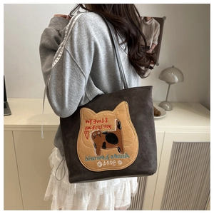 Detail of grey tote bag featuring a cute cat patch and contrast embroidery texture