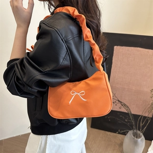 Fashionable orange pleated shoulder bag with white bow embroidery and scrunchie handle