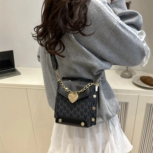 Chic black mini crossbody bag with gold heart lock and chain strap for women