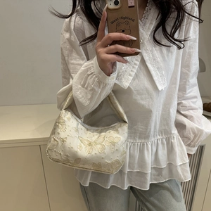 Elegant cream white underarm bag with gold butterfly embroidery and zipper closure