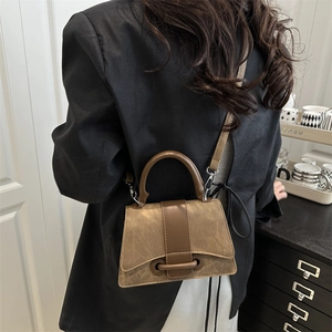 Retro brown hourglass shoulder bag with adjustable strap and textured finish