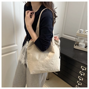 Detail of canvas tote bag with drawstring inner pouch and minimalist casual shoulder strap