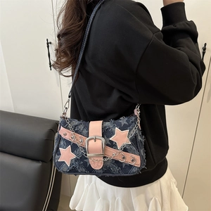 Y2K denim shoulder bag with pink stars and metal chain detail shown on a model