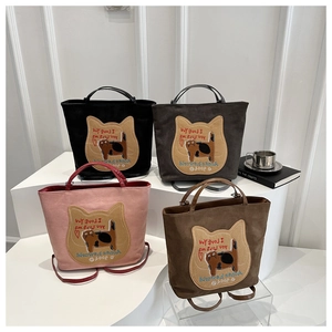 Detailed display of tote bags with cat embroidery in black, grey, pink and brown