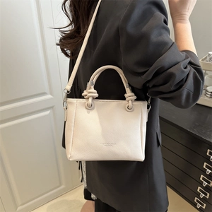 Chic beige lychee leather small square tote bag with knotted handles and crossbody strap