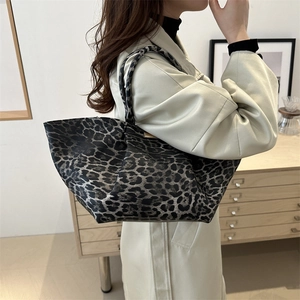 Stylish large capacity leopard print tote bag for women showing side shoulder carry style