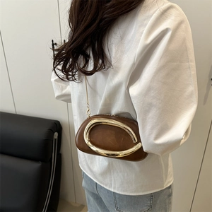 Chic dark brown leather round crossbody bag with artistic irregular gold metal buckle