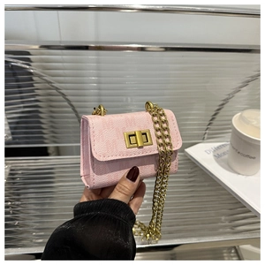 Close-up of pink textured mini bag with golden twist lock and metal chain strap