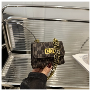 Detail of vintage brown monogram mini bag with gold chain strap and turn-lock closure
