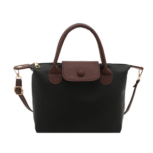 Chic black lychee grain pillow bag with brown flap and golden hardware for women