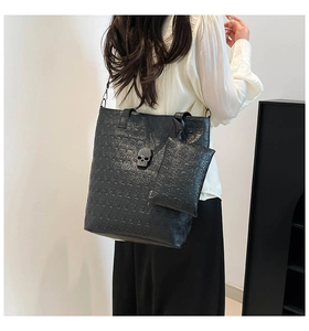 Gothic black leather tote bag featuring skull embossing and 3D rhinestone skull detail