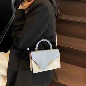 Fashionable blue and white color-block crossbody bag with woven handle and V-shaped flap