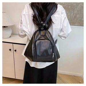 Detailed back view of a black teardrop-shaped PU leather backpack worn by a model