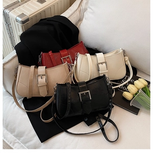 Detail view of stylish square shoulder bags in red, beige, white, and black leather colors