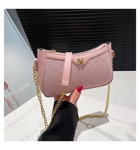 Detail of pink PU leather shoulder bag featuring golden chain and metal M logo hardware