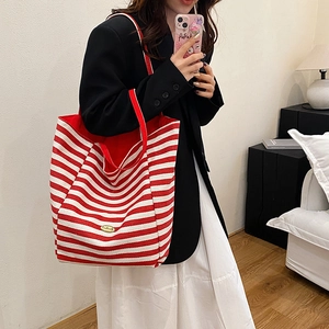 Chic red and white striped canvas tote bag with gold metal logo for women on shoulder