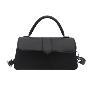 Minimalist matte black square handbag with triangular flap and detachable strap for women
