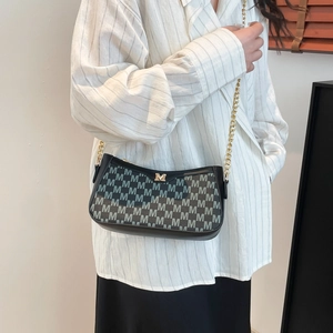 Chic crescent underarm bag with monogram print and golden chain strap on model