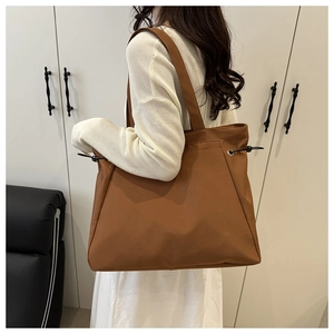 Brown large-capacity tote bag with side drawstring details and wide shoulder strap