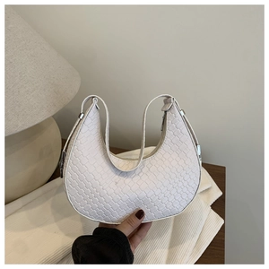 Close-up of white hobo bag showing woven embossed texture and silver zipper detail