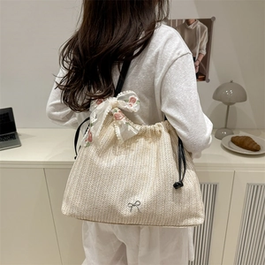 Minimalist straw tote bag with lace floral bows and black leather shoulder straps