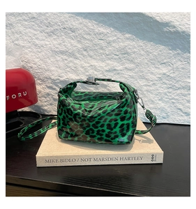 Detail of green and black leopard print tote with glossy finish and top handles