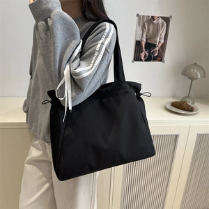 Minimalist black large capacity nylon tote bag for women with drawstring closure