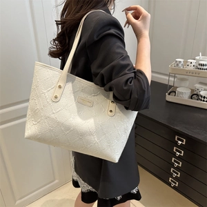 Minimalist white tote bag with textured surface and large capacity for daily commuting