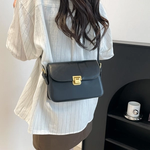 Minimalist black leather crossbody square bag with vintage gold buckle on model