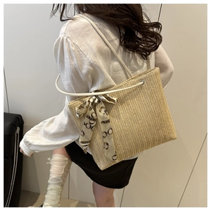 Straw tote bag with cream rope handles and vintage silk scarf detail for summer