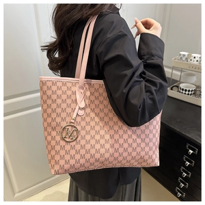 Detail of pink tote bag with M-pattern print and gold metallic M-logo charm detail