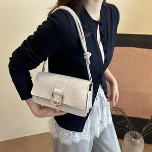Minimalist cream shoulder bag with crocodile texture and golden horseshoe buckle