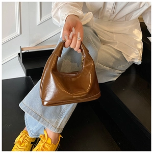 Détail du sac hobo marron brillant avec finition cuir lisse et fermeture éclair