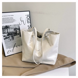 Detail view of cream white PU leather tote bag with soft texture and magnetic buckle