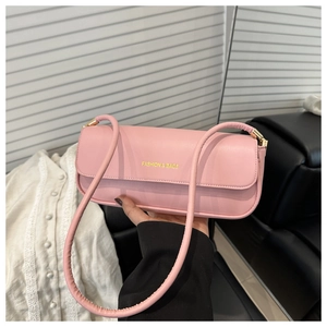 Detail of pink matte leather shoulder bag with gold metal hardware and logo