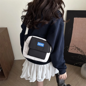 Minimalist black and white canvas crossbody bag with adjustable strap for casual wear