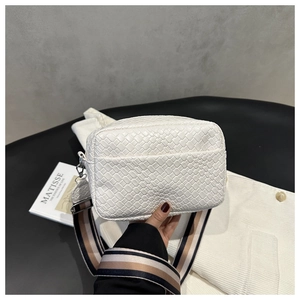 Detail of white woven PU leather crossbody bag with striped wide shoulder strap
