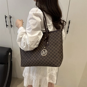 Fashionable dark brown tote bag with M-letter pattern for commuting and daily use