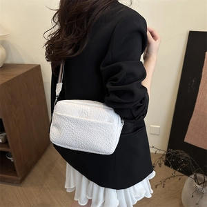 Minimalist white textured crossbody bag for women with woven pattern and wide shoulder strap