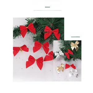 Close-up of red, gold and silver Christmas bows on festive tree branches with stars