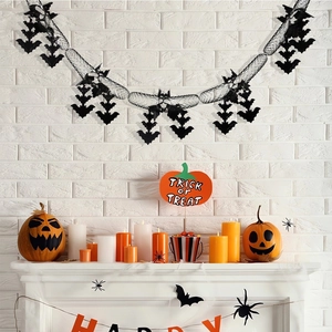 Halloween party decoration set with pumpkin banner and black bat garland on white wall