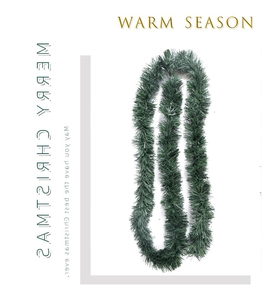 Close-up of deep green PVC artificial Christmas garland for festive home decoration