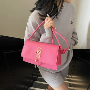 Chic bright pink square crossbody bag with golden SS logo and elegant tassel detail