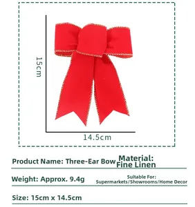 Macro detail of red linen Christmas bow decoration with gold stitched edges and 15cm size