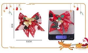 Detailed size and weight view of a red Christmas bow with gold bell and Merry Christmas print