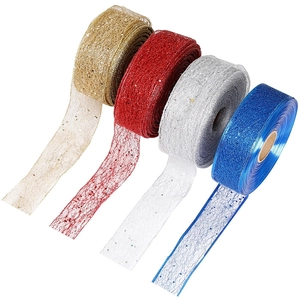 Detail of four-color glitter mesh ribbons in red, gold, silver and blue for gift wrapping